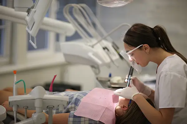 Dentist performing a restorative dental procedure on a patient at Cascadia Family Dental in Bend, OR.